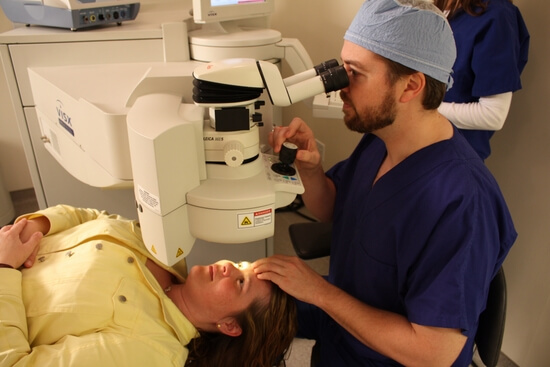 Dr McCormick using LASIK machine